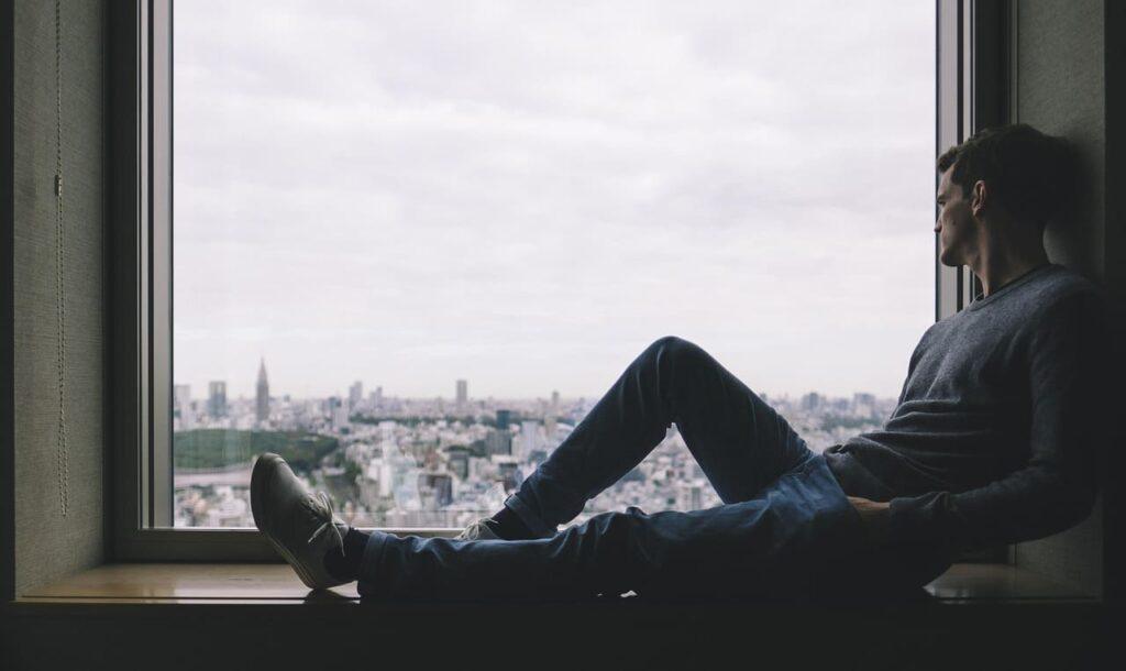 Man feeling unmotivated, reflecting on his journey.
