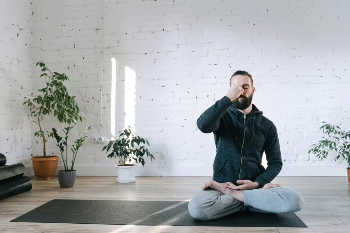 Man doing meditation as a way to stay motivated.