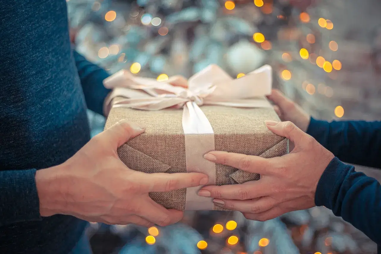 Two people exchanging gifts in a toxic family dynamic during holidays.