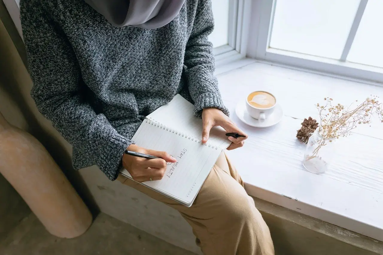 Woman journaling as a way to improve self-esteem and build confidence.