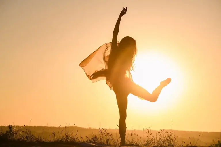 Woman that learned how to improve self esteem and build confidence dancing in the sun.