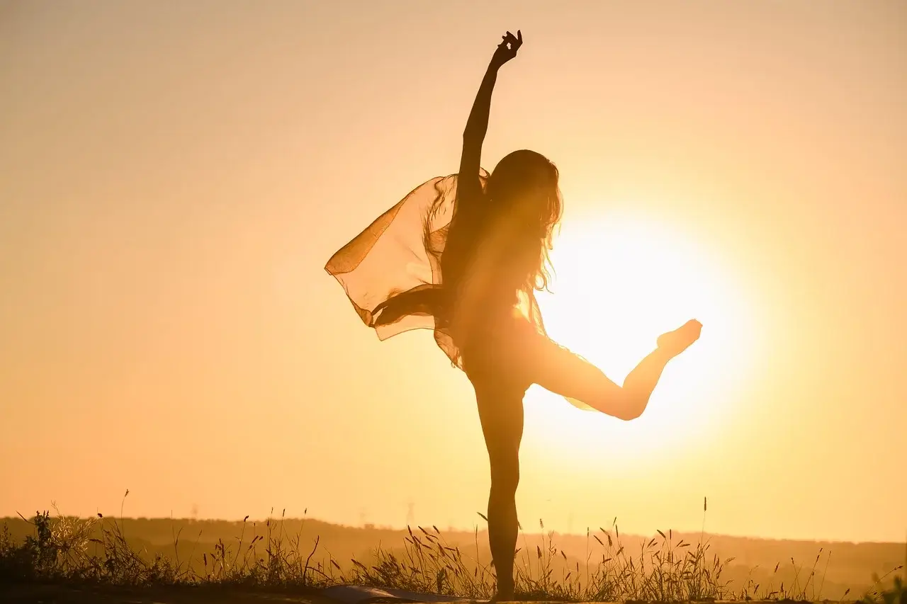 Woman that learned how to improve self esteem and build confidence dancing in the sun.