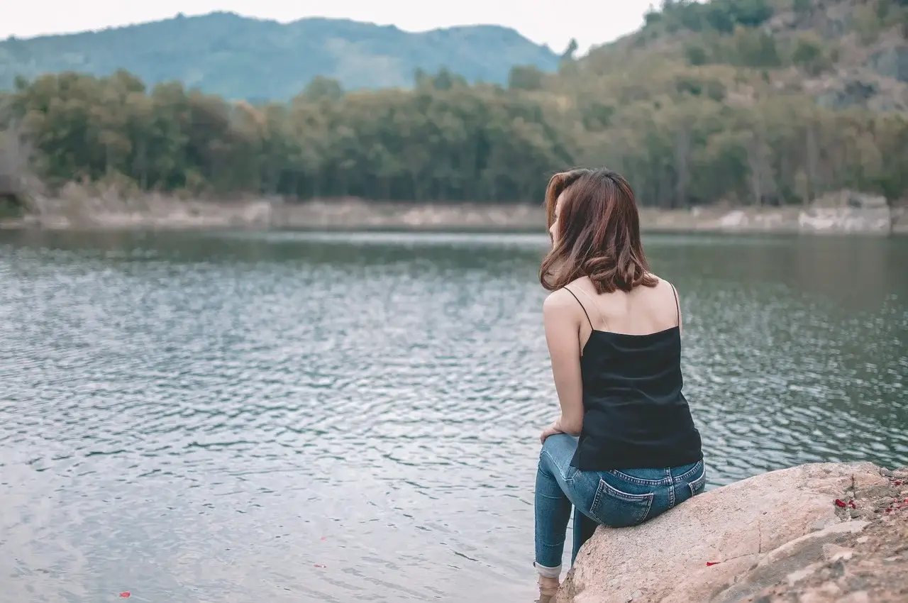 Woman reflecting and thinking about ways to love yourself more.
