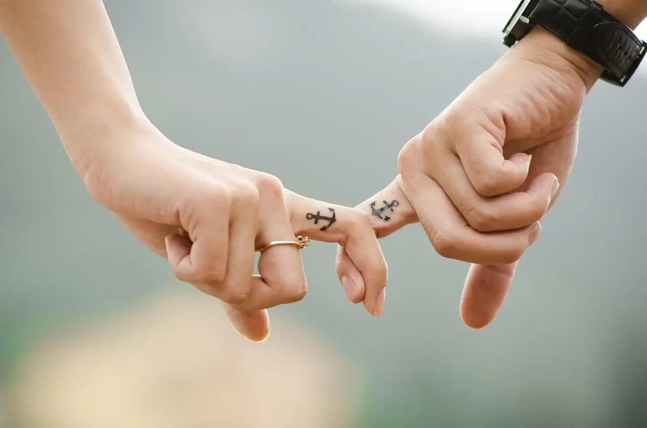 People holding hands, representing a couple that followed tips on healthy relationships.