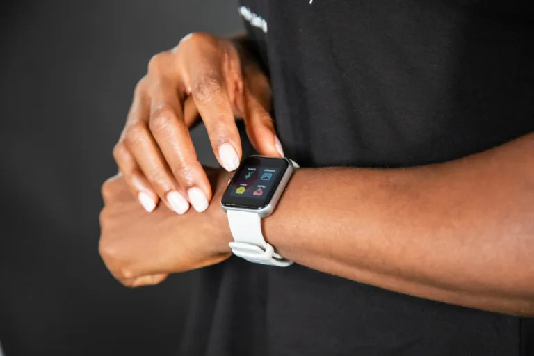 Woman using a smartwatch as one of her fitness gadgets.