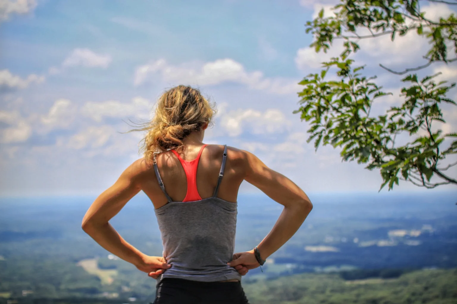 Fit woman exercising on a mountain as a part of a healthy lifestyle.