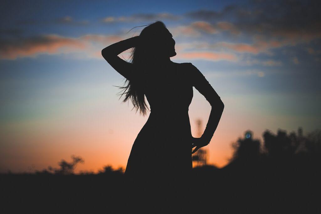 Woman silhouette being confident after practicing positive daily affirmations for women. 
