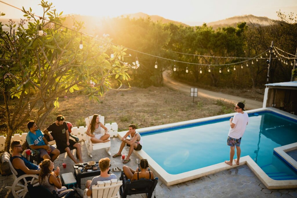 A group of friends in summer by the pool, representing fun things to do in summer with friends.