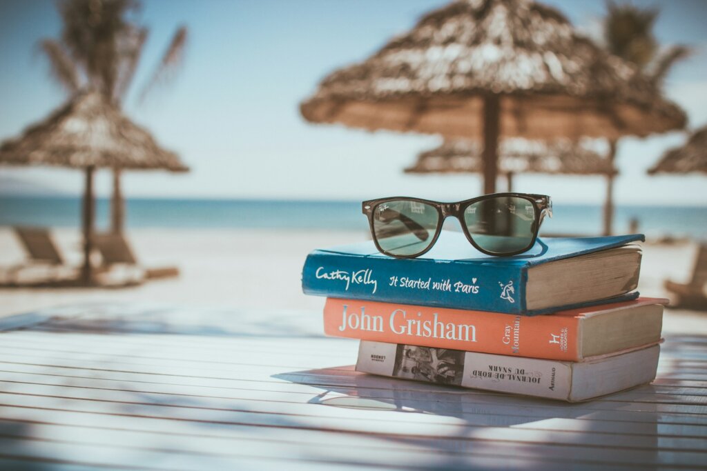 A stack of books on the beach.