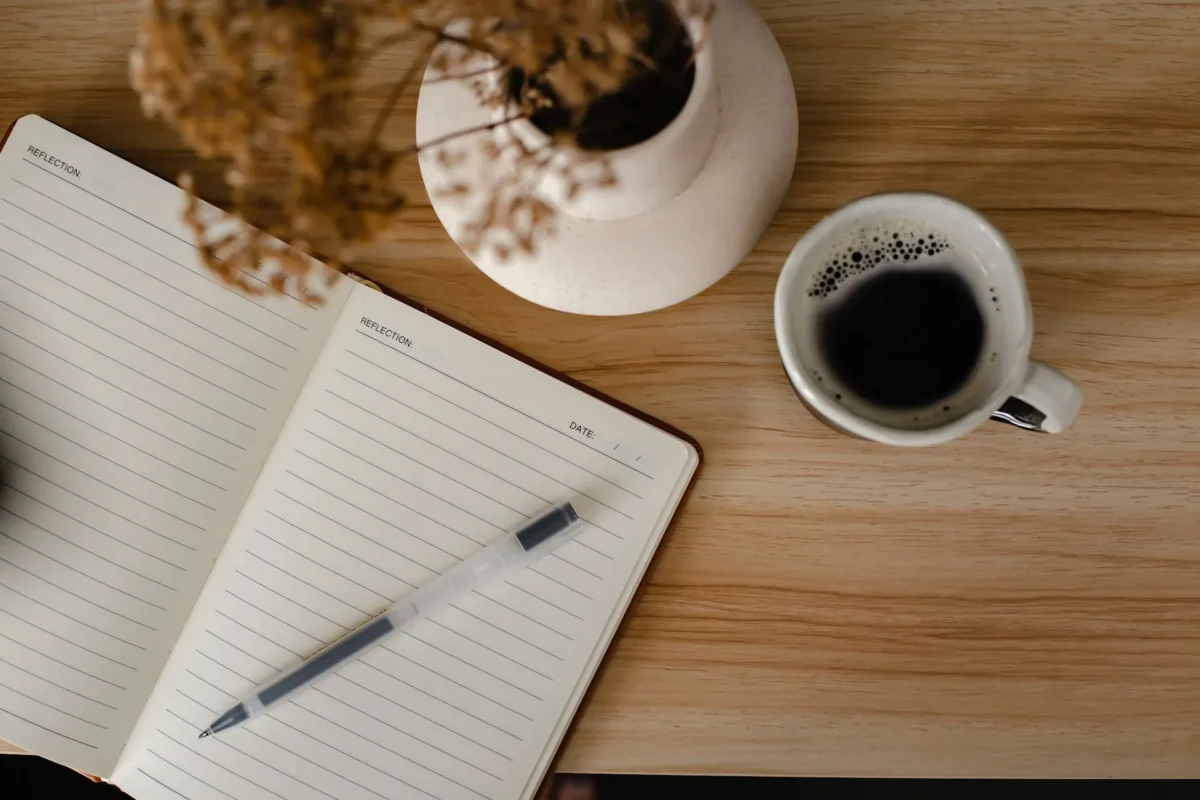 Journal on the table used for writing journal prompts for self growth.