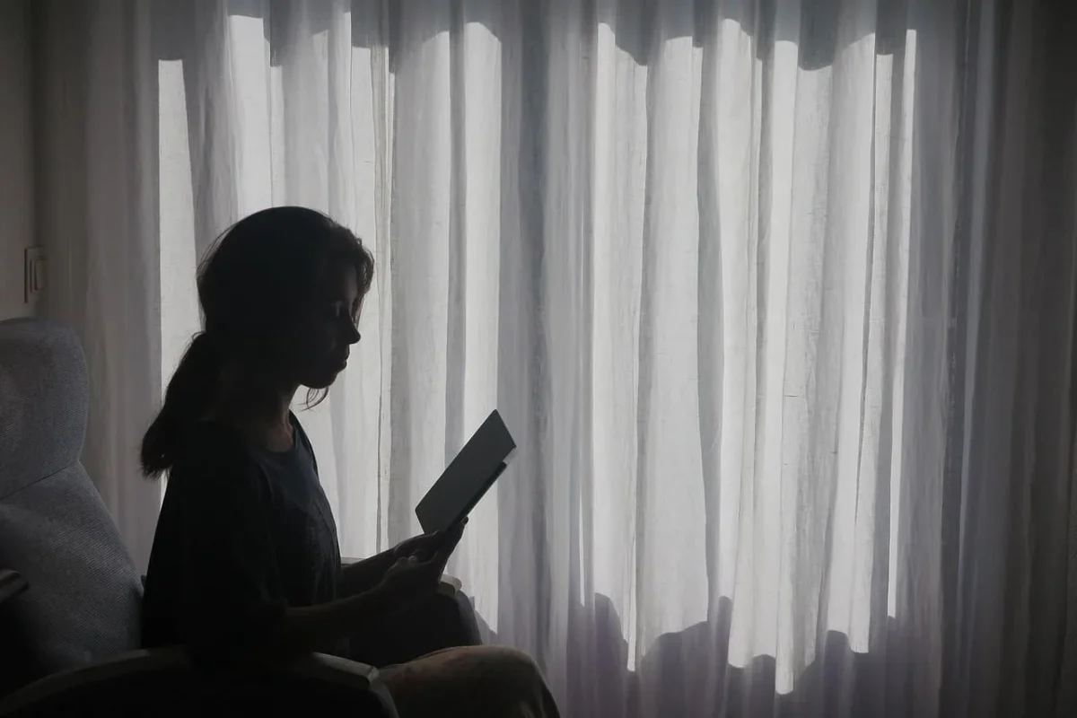 Woman reflecting on her shadow work prompts.