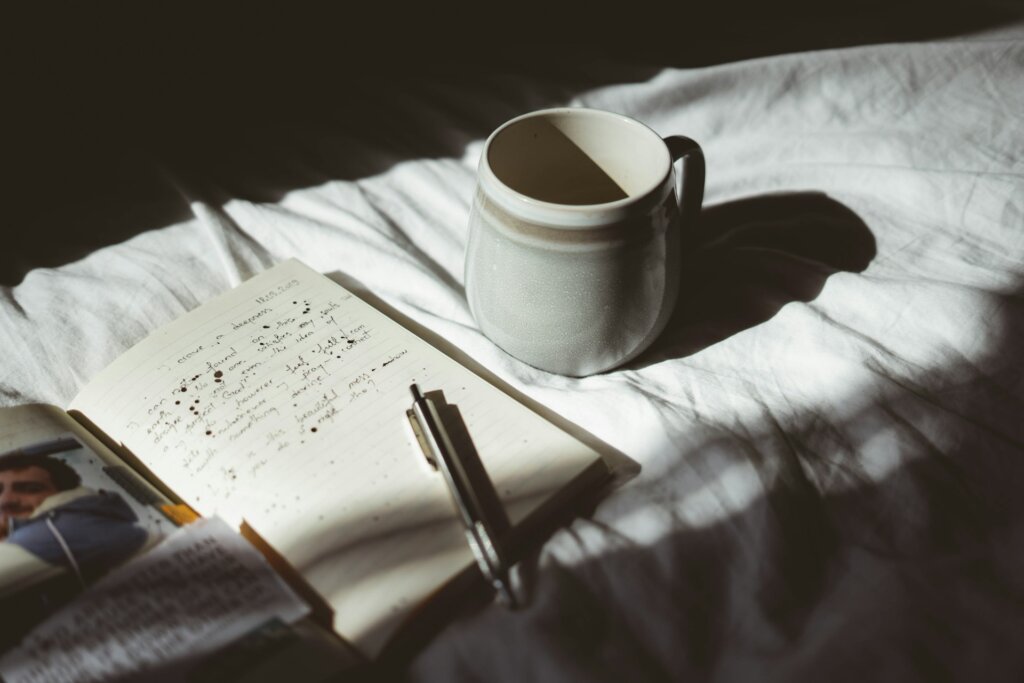 Journal on the bed in shadow.
