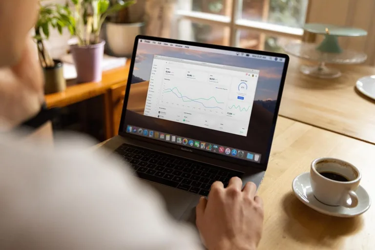 Man reading self improvement statistics on his laptop.