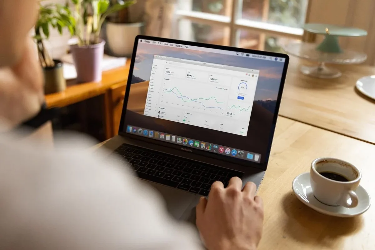 Man reading self improvement statistics on his laptop.