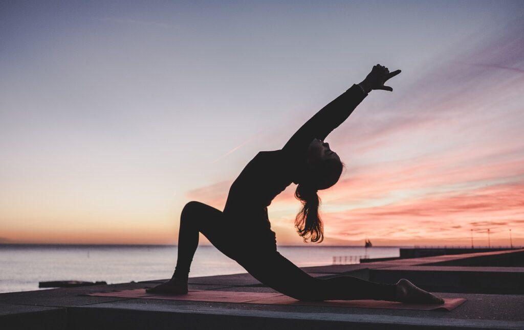 Woman doing yoga as one of the best habits to have.