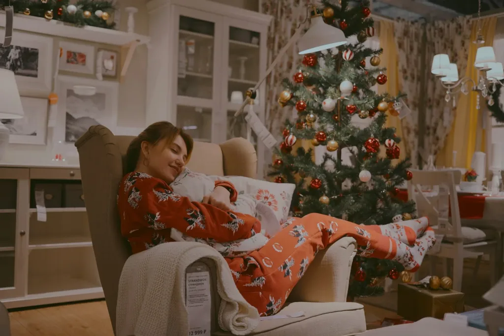 Woman at home during Christmas season, cuddled with a blanket which was her Christmas gift.