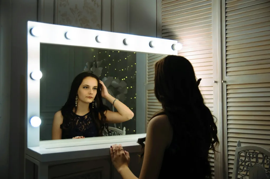 Woman in front of a makeup mirror, which was on her Christmas wishlist 2025.