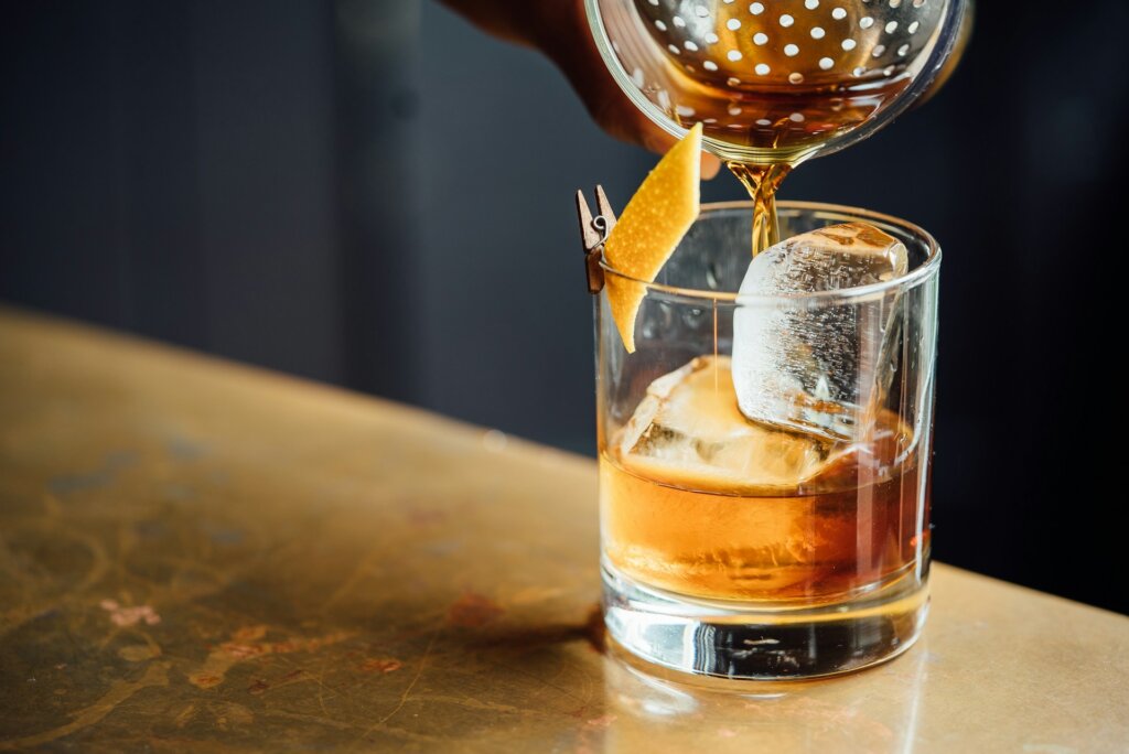 Man pouring a whiskeyin a glass, one of the unique valentines day gifts for him.
