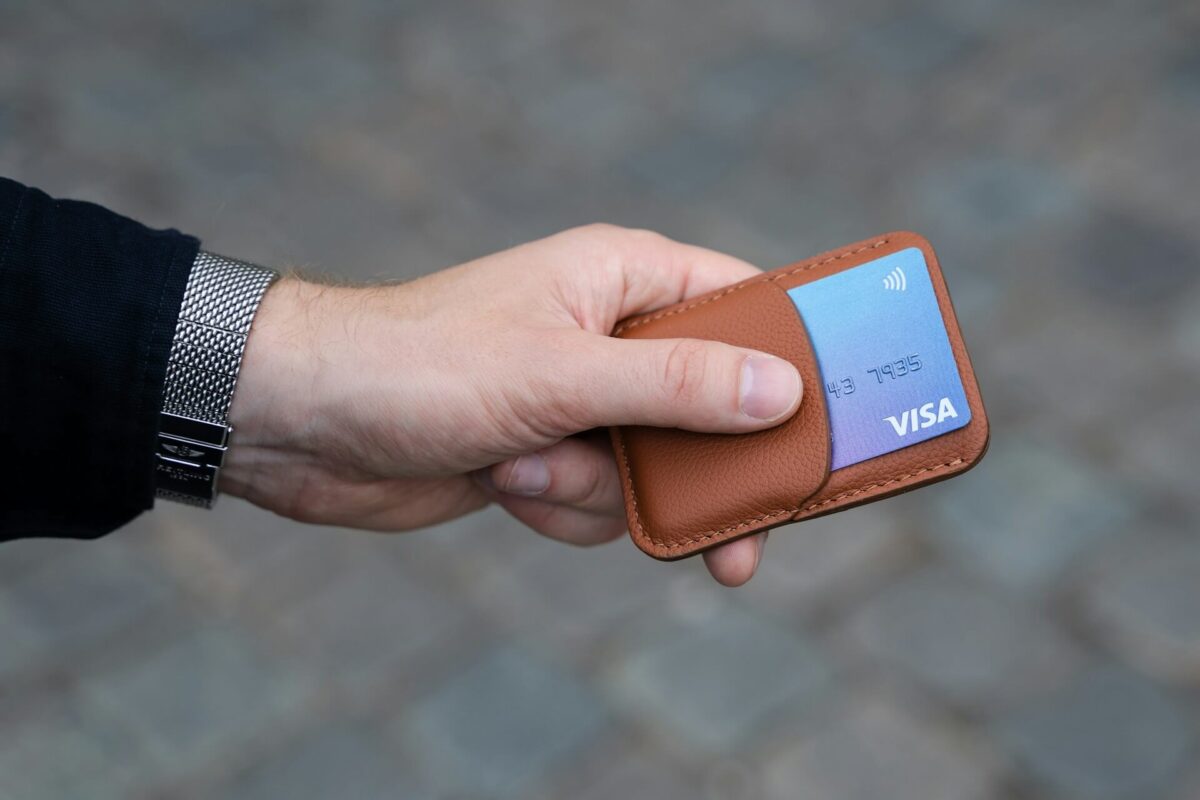 Man holding a wallet, one of the best Valentines gifts for him.