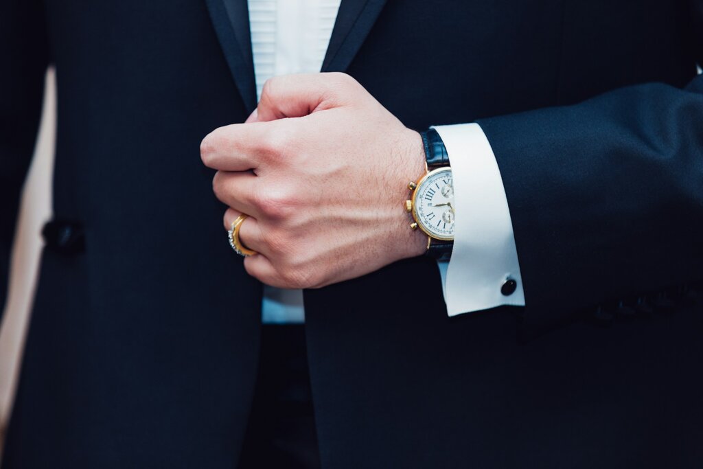 Man in a suit wearing a watch, one of the great Valentines gifts for men.