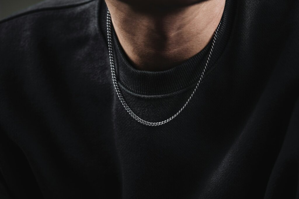 Man wearing a chain necklace.