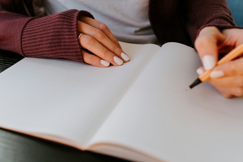 Woman journaling, representing habits for reinventing yourself.