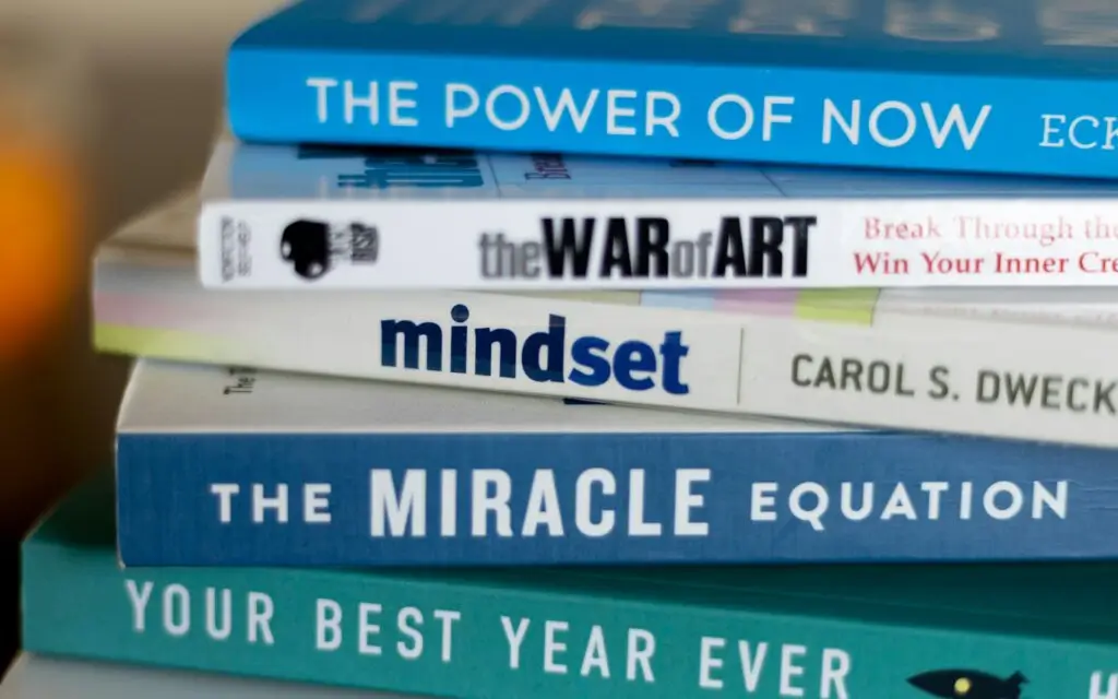 A stack of books, representing the best self-help books of all time.