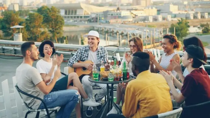 A group of friends hanging out on a rooftop, after learning how to make friends as an adult.