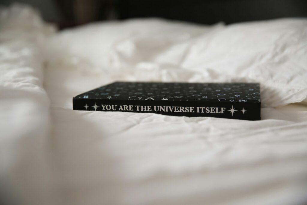 Spiritual journal on the bed, representing the best manifestation journal examples.