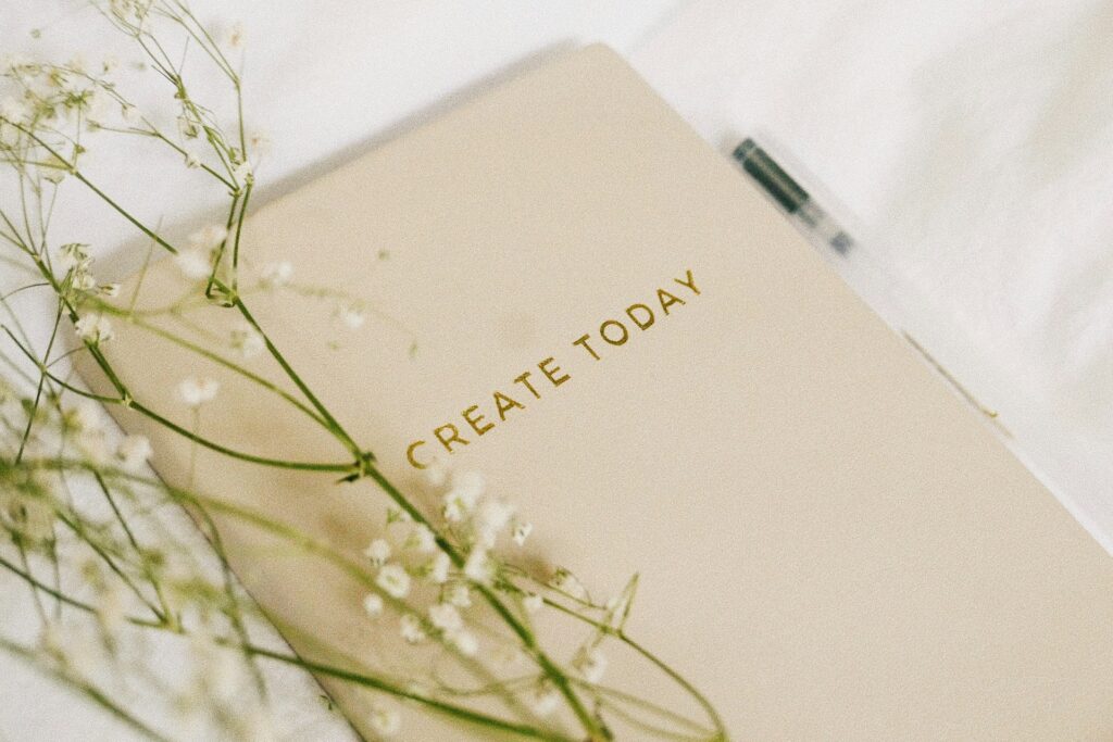 A journal on the bed, representing one of the best Law of Attraction journal examples.