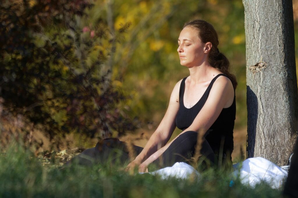 Woman reflecting on her energy after learning how to manifest love through alignment.
