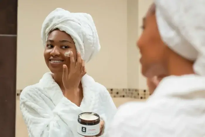 Woman doing her skincare routine after learning tips on how to glow up quickly.
