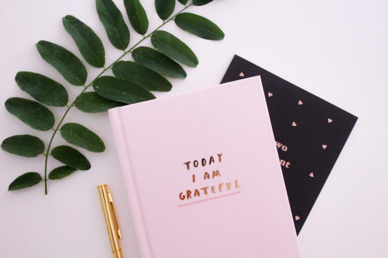 A gratitude journal on a desk, representing a place to practice gratitude journal prompts for adults.