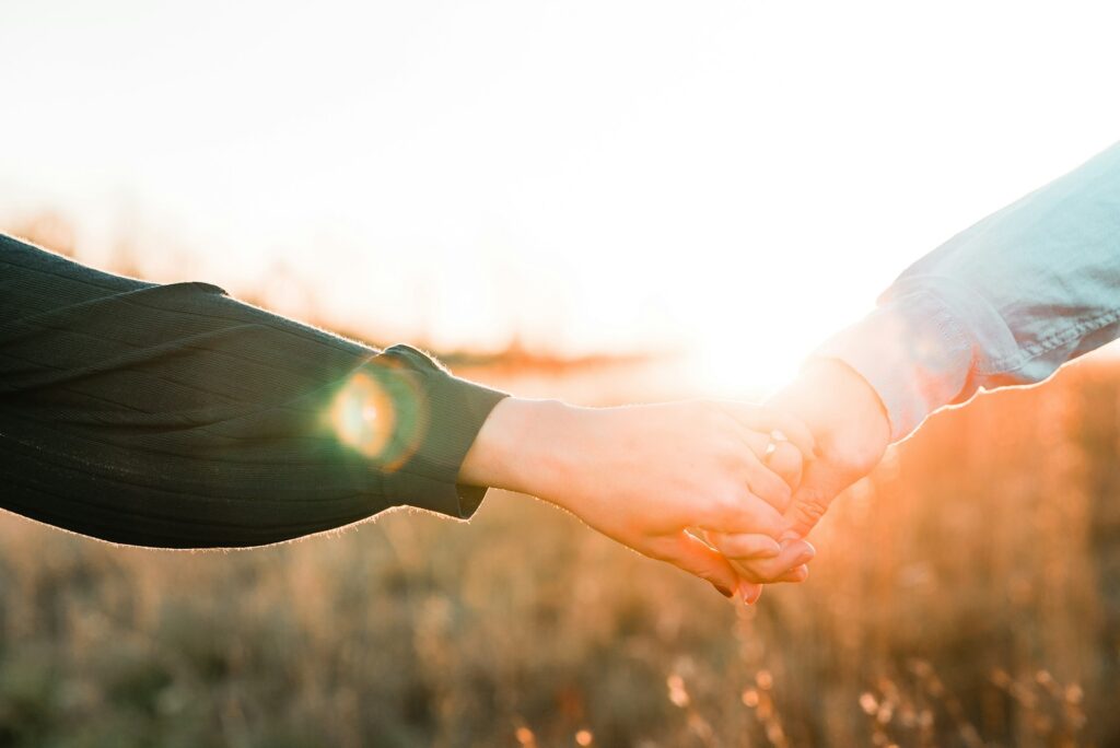 Two people holding hands, being grateful for their relationship.