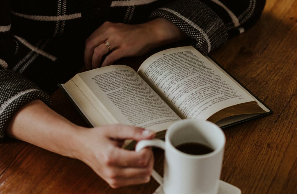Woman reading a book after learning how to do a digital detox.