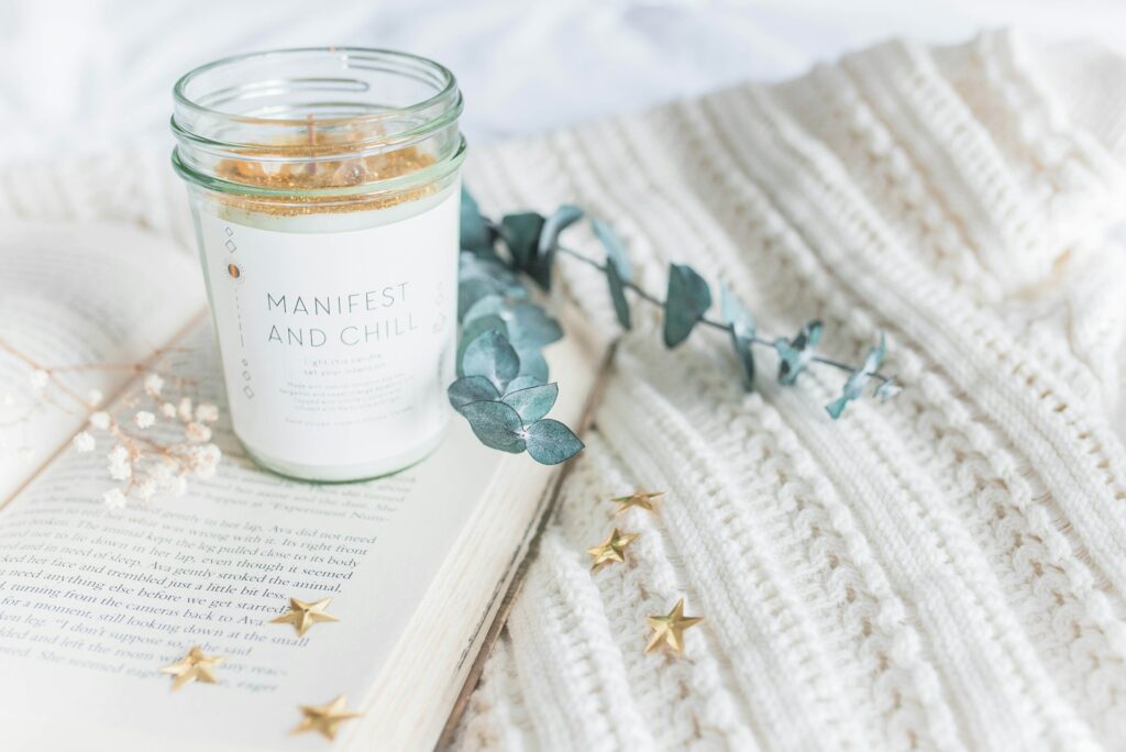 A candle and a manifestation journal necessary for new moon manifesting.